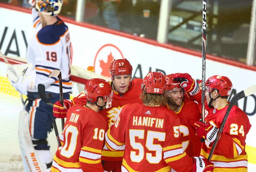 Flames celebrate a second period goal by Dillon Dube (facing camera) during NHL action between the Edmonton Oilers and the Calgary Flames in Calgary on Saturday, January 11, 2020. Jim Wells/Postmedia