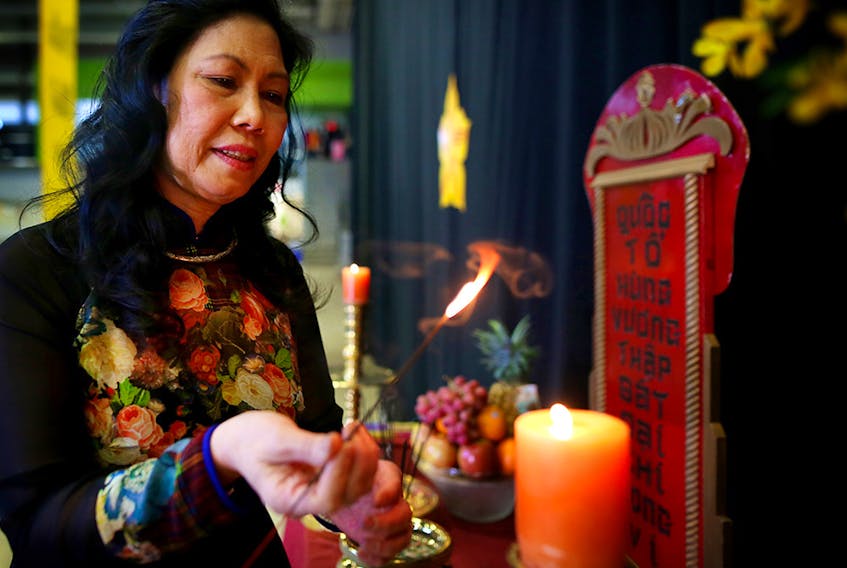 Tuyet Lam prays during the start of the Lunar New Year festival for the Vietnamese community at the Genesis Centre in Calgary, Alta., on Saturday January 14, 2017. 