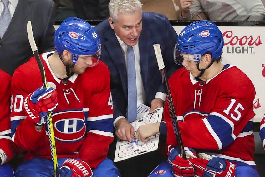 Montreal Canadiens assistant coach Dominique Ducharme talks strategy with Joel Armia, left, and Jesperi Kotkaniemi during third period of game against the Florida Panthers in Montreal on Jan. 15, 2019. 