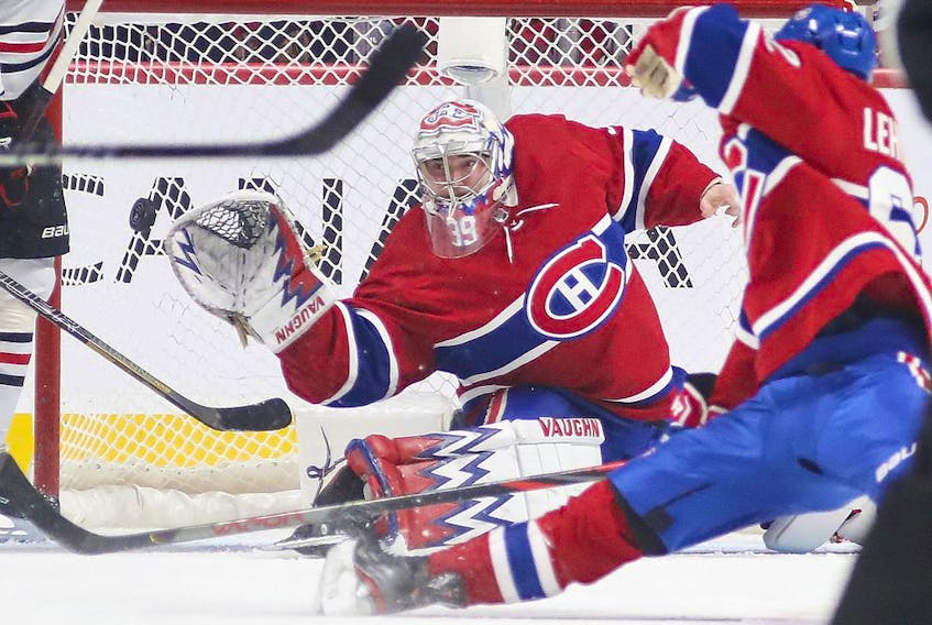 Montreal Canadiens' Charlie Lindgren slides across the crease to stop Chicago Blackhawks Dominik Kubalik during third period in Montreal on Jan. 15, 2020. 