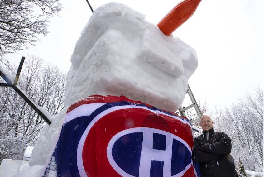 Derek Parker with his giant Olaf Canadiens snowman in Montreal on Saturday, Jan. 16, 2021.  