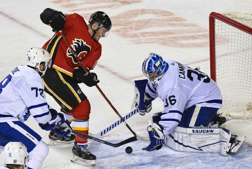A shot by the Calgary Flames’ Matthew Tkachuk is saved by Toronto Maple Leafs goaltender Jack Campbell during the third period at the Saddledome in Calgary on Sunday, Jan. 24, 2021.