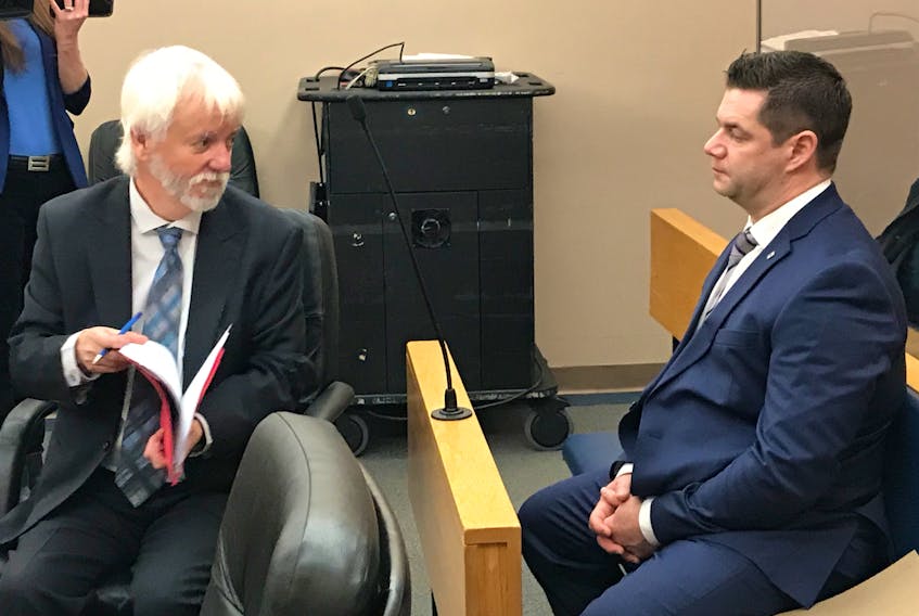 RNC Const. Steve Curnew (right) speaks with his lawyer, Randy Piercey, in provincial court Friday morning in St. John's.