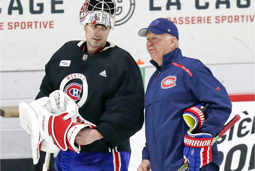 Carey Price has a conversation with coach Claude Julien during Montreal Canadiens practice at the Bell Sports Complex in Brossard on Jan. 31, 2019.