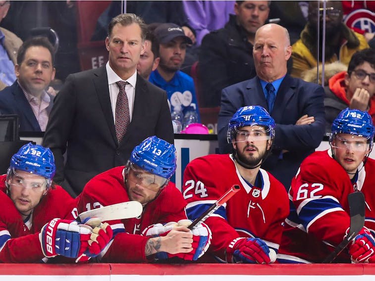 Canadiens associate coach Kirk Muller (left) and head coach Claude Julien watch action from behind bench.