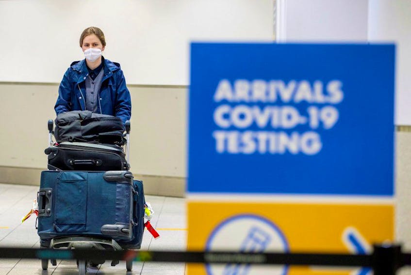  A passenger arrives at Toronto’s Pearson airport after mandatory COVID-19 testing took effect for international arrivals in Mississauga, Ontario, February 1, 2021.