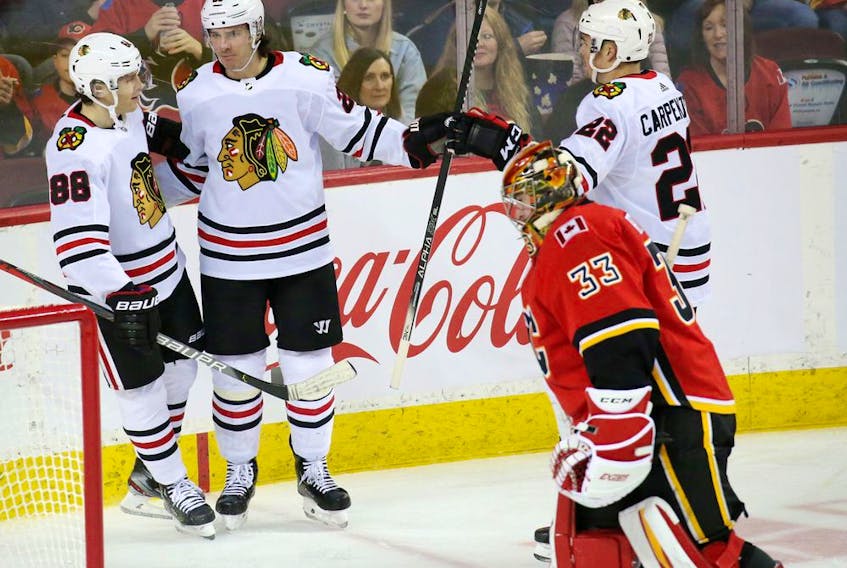 The Chicago Blackhawks celebrate scoring on Calgary Flames goalie David Rittich during NHL action in Calgary on Saturday, February 15, 2020.  Gavin Young/Postmedia