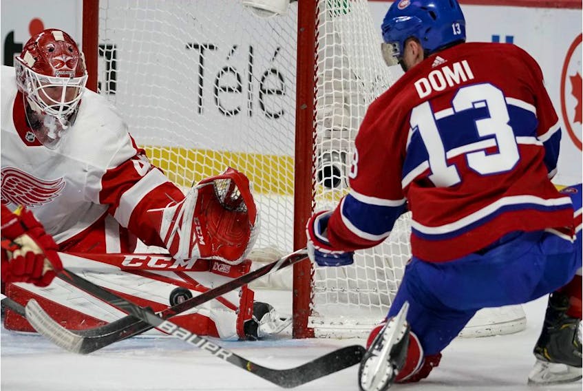  Montreal Canadiens’ Max Domi falls as he shoots on Detroit Red Wings goaltender Jonathan Bernier in Montreal on Dec. 14, 2019.