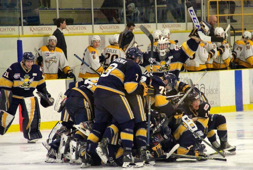 The Spruce Grove Saints mob Cole Basnett after he delivered the game-winning goal in triple overtime of Game 5 of the Alberta Junior Hockey League quarter-final series against the Grande Prairie Storm last year.
