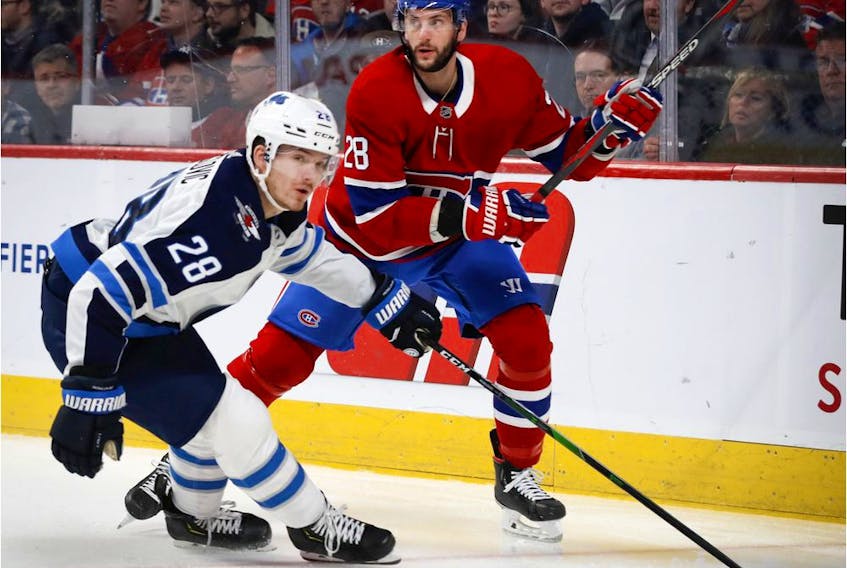  Winnipeg Jets centre Jack Roslovic tries to slow Montreal Canadiens defenceman Marco Scandella in Montreal, on Jan. 6, 2020.