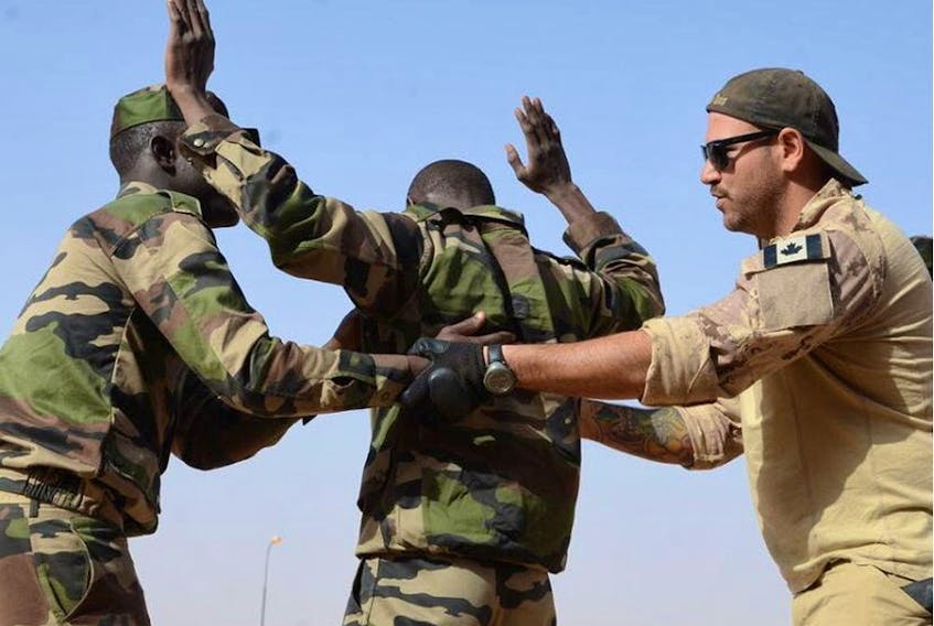 A Canadian Special Operations Regiment instructor teaches soldiers from the Niger Army how to properly search a detainee in Agadez, Niger, Feb. 24, 2014 during that year's Flintlock exercise. 