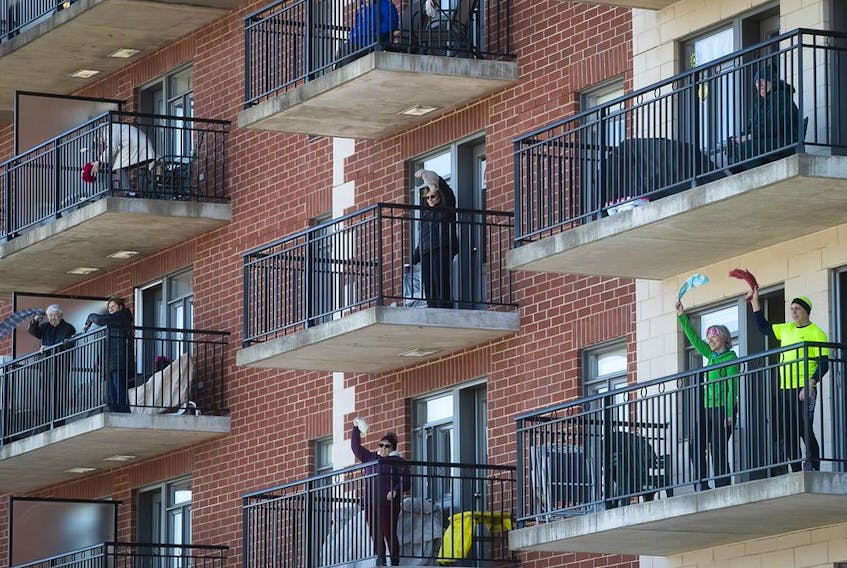  Seniors participate in an outdoor Zumba class from the balcony of a seniors’ residence in Blainville on Friday, March 27, 2020.