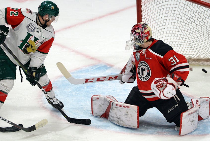 Halifax Mooseheads forward Samuel Asselin spots the puck in the net after teammate Maxim Trepanier beat Quebec Remparts goalie Carmine-Anthony Pagliarulo during the first period of Thursday’s QMJHL playoff game at the Centre Videotron in Quebec City.  Erick Labbe/Le Soleil