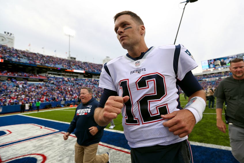 Patriots' Tom Brady runs off the field after defeating Buffalo on Sunday. (GETTY IMAGES)