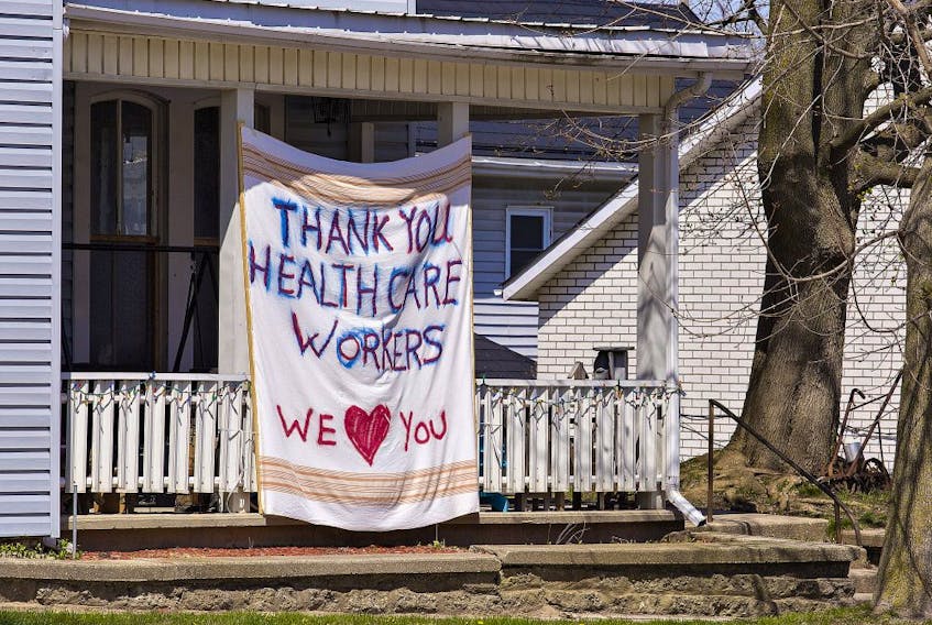  A message thanking healthcare workers is written on a bed sheet and hung on the front of a West Street home near Norfolk General Hospital on Saturday April 25, 2020 in Simcoe, Ontario.