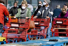 Due to COVID-19, shoppers line up in front of Loblaws, separated in rows by stacked wooden pallets on Thursday April 9, 2020 at the Leslie St location in Toronto. 