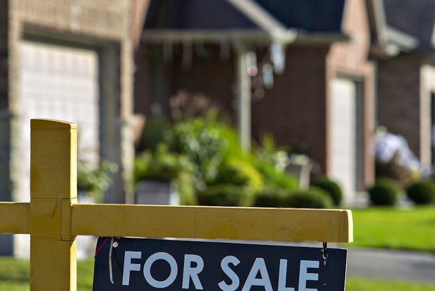 A "for sale" sign is posted outside a home in this file photo.