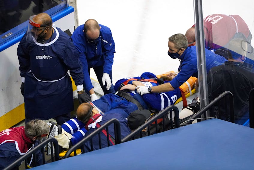 Leafs defenceman Jake Muzzin is carried off the ice on a stretcher during Tuesday's game.