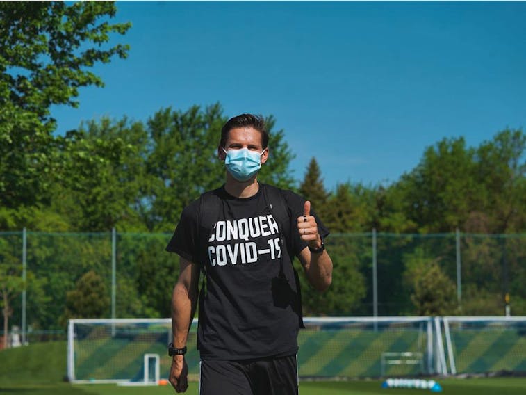 Montreal Impact player Jukka Raitala wears a Conquer COVID-19 T-shirt at the team’s Centre Nutrilait practice facility.

