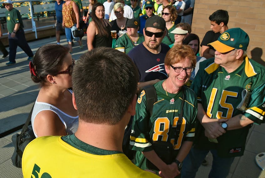 A volunteer sells 50-50 tickets at Commonwealth Stadium in Edmonton on July 14, 2017.