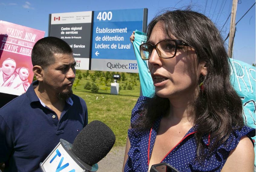 Protesters Amy Darwish, right, and Carmelo Monge outside the Laval Leclerc Institute on Monday July 15, 2019. 