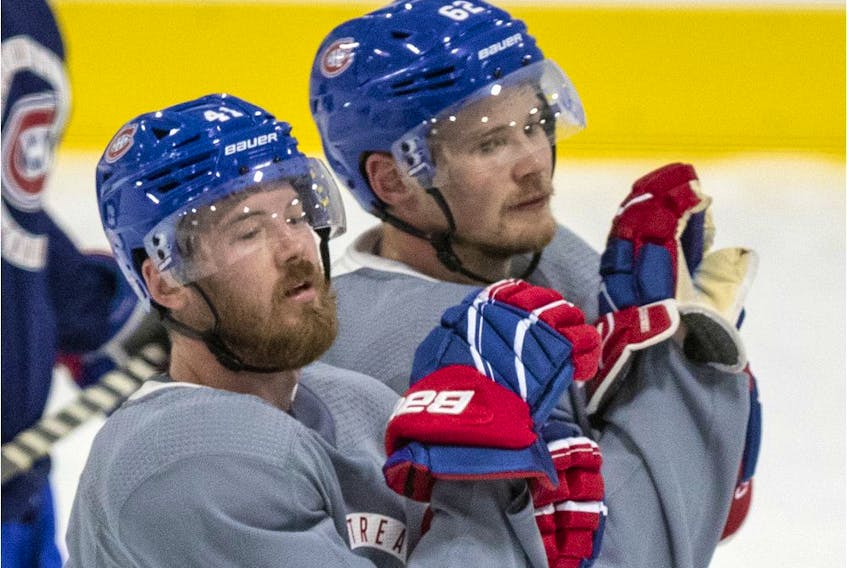 Linemates Paul Byron (left) and Artturi Lehkonen wait their turn during a Canadiens training-camp drill at the Bell Sports Complex in Brossard.