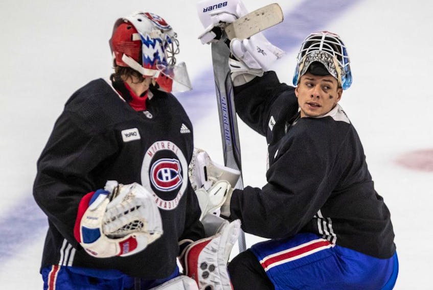 Canadiens goalies Charlie Lindgren (left) and Michael McNiven chat during practice at the Bell Sports Complex in Brossard on Thursday.