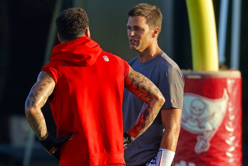 Tampa Bay Buccaneers' Tom Brady (right) and Mike Evans talk during practice this week.