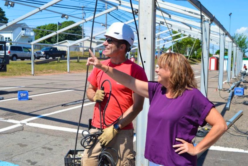 Sandra Hodder Acorn, events manager for Old Home Week, checks on one of the bigger tents going up on the grounds in Charlottetown with Tim McCandless of Commercial Tent Rentals and Sales.