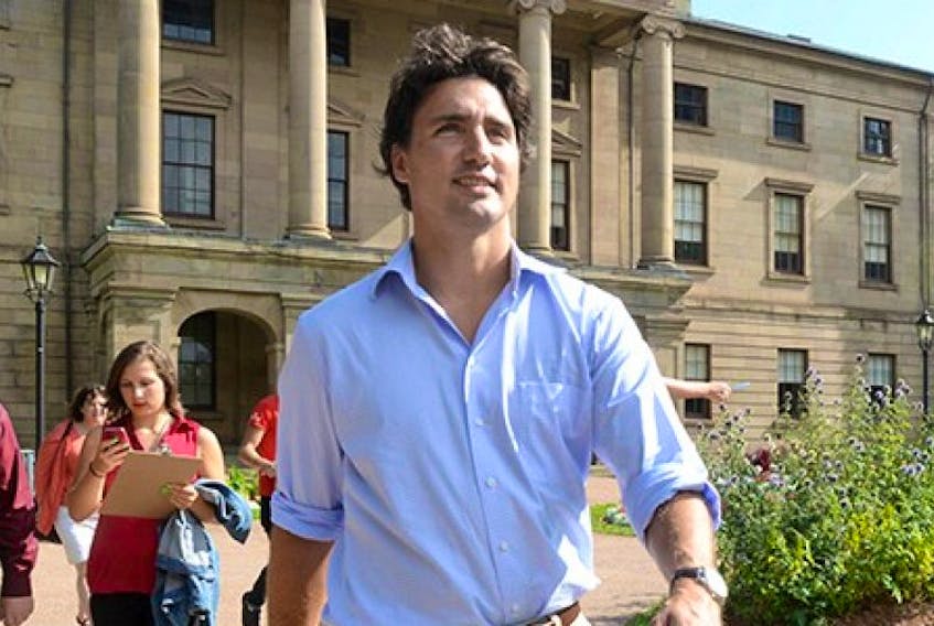 Liberal Leader Justin Trudeau walks past Province House during a tour of Charlottetown on Tuesday, Aug. 27, 2013.