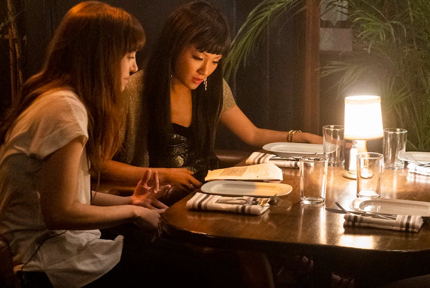 Director Lorene Scafaria and Constance Wu behind the scenes on the set of Hustlers.   