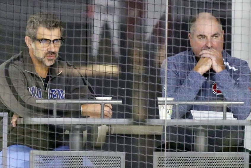 Larry Carrière, right, and Canadiens general manager Marc Bergevin watch training camp practice at the Bell Sports Complex in Brossard on Sept. 14, 2018.