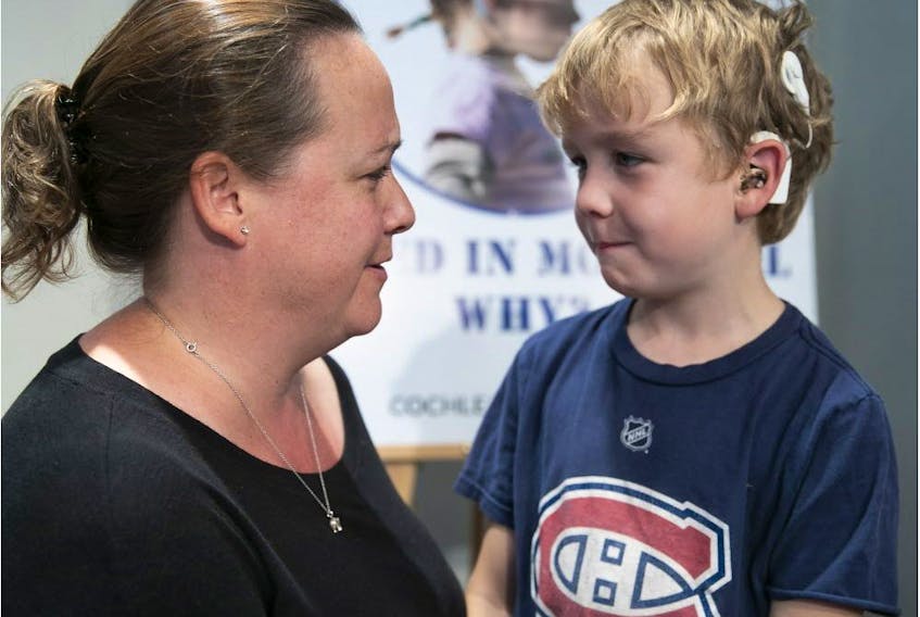 Oscar Geraghty and his mother, Beaconsfield city councillor Dominique Godin, at press conference in Montreal City Hall on Sept. 17, 2018 to help establish a program for cochlear implant surgery.
