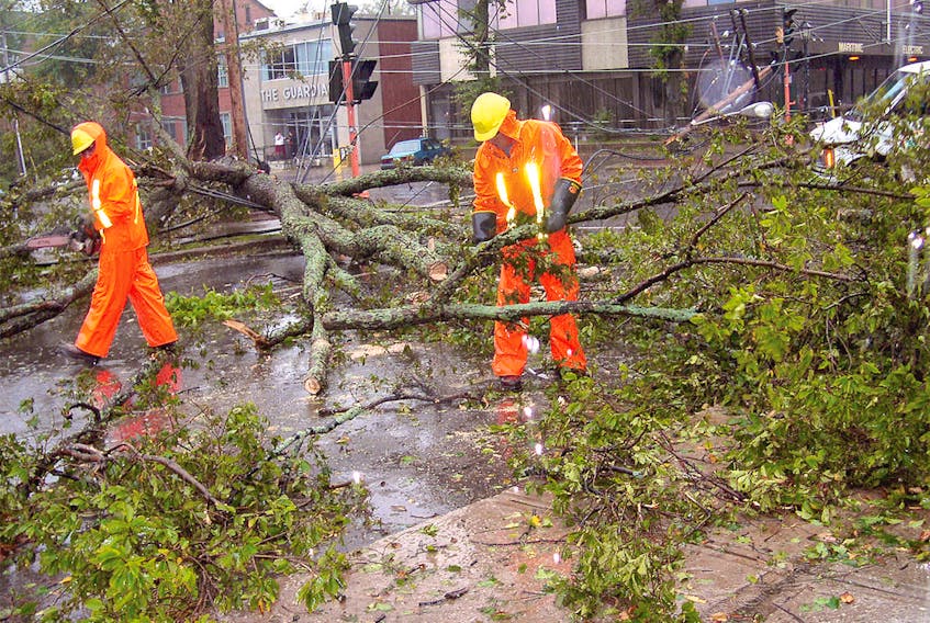Maritime Electric and Bell crews faced a tangled web of power, cable and telephone lines at the corner of Kent and Prince streets in Charlottetown following the powerful storm. -Guardian file photo