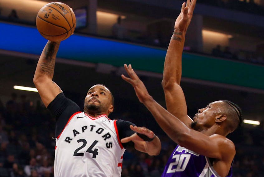 Toronto Raptors guard Norman Powell, left, goes to the basket against Sacramento Kings forward Harry Giles III, right, during the first quarter of an NBA basketball game in Sacramento, Calif., Sunday, March 8, 2020. 
