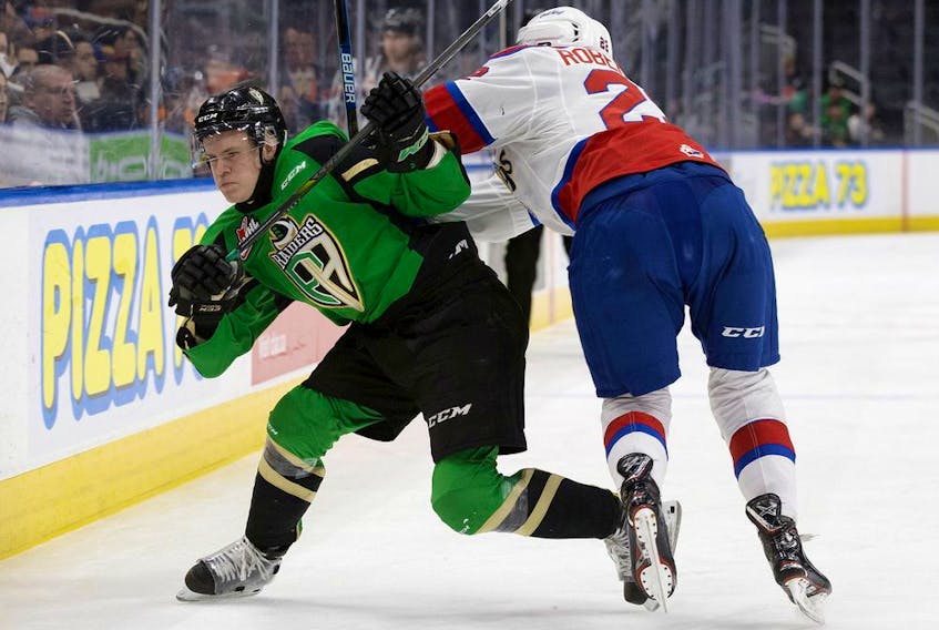 Prince Albert Raiders defenceman and Canadiens first-round draft pick Kaiden Guhle rolls off a check by Matthew Robertson of the Edmonton Oil Kings during WHL Eastern Conference Championship game in April 2019. 