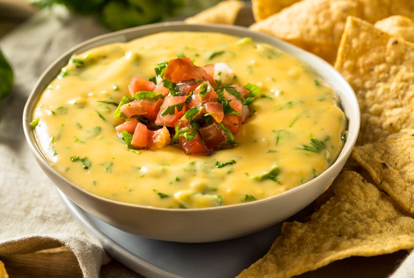 Queso dip with tortilla chips.