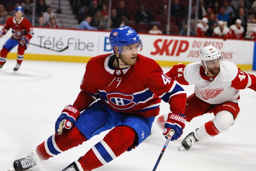 Montreal Canadiens winger Joel Armia and Detroit Red Wings centre Luke Glendening during action in Montreal on Oct. 15, 2018. 