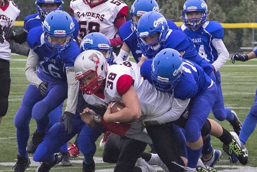 The Spruce Grove Cougars gang tackle a West Edmonton Raiders ball carrier in Capital District Minor Football Association play in September 2019. The association has announced the cancellation of the 2020 Spring season due to COVID-19 measures.