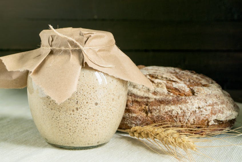 Active rye sourdough starter in a glass jar for homemade bread.