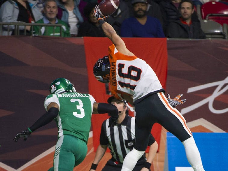B.C. Lions receiver Bryan Burnham hauls in a pass despite pressure from the Saskatchewan Roughriders' Nick Marshall during CFL action at BC Place, in Vancouver on Oct. 18.  The catch was ruled incomplete, out of bounds. File photo by Gerry Kahrmann/Postmedia. 