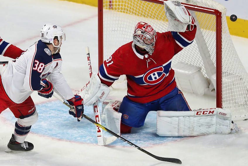  Canadiens goaltender Carey Price deflects the shot of Blue Jackets’ Boone Jenner past the net during first-period action at the Bell Centre Tuesday night.