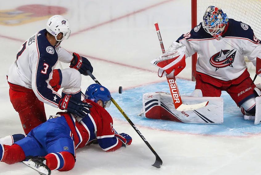  Canadiens’ Max Domi slides toward Columbus Blue Jackets goaltender Elvis Merzlikins after being brought down by Columbus Blue Jackets’ Seth Jones during second period in Montreal on Nov. 12, 2019.