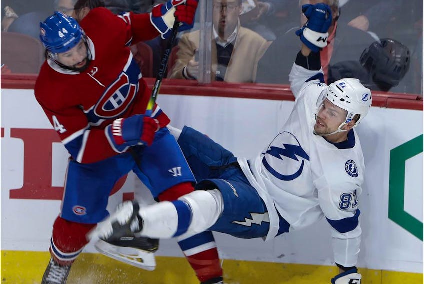  Montreal Canadiens centre Nate Thompson dumps Tampa Bay Lightning defenceman Erik Cernak in Montreal, on Oct. 15, 2019.
