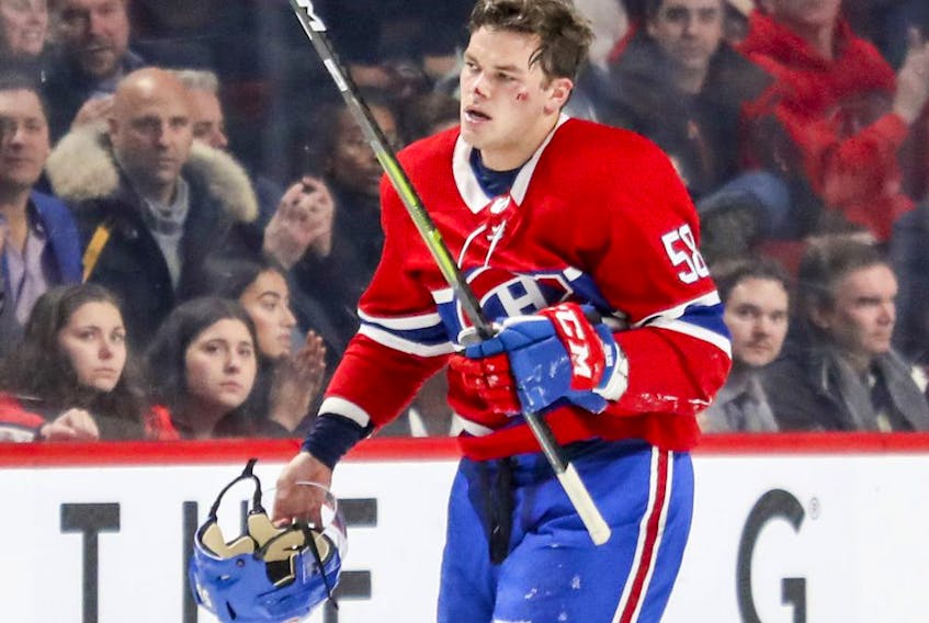 Canadiens' Noah Juulsen heads to the bench after taking a puck to the face against the Washington Capitals in Montreal on Nov. 19, 2018. 