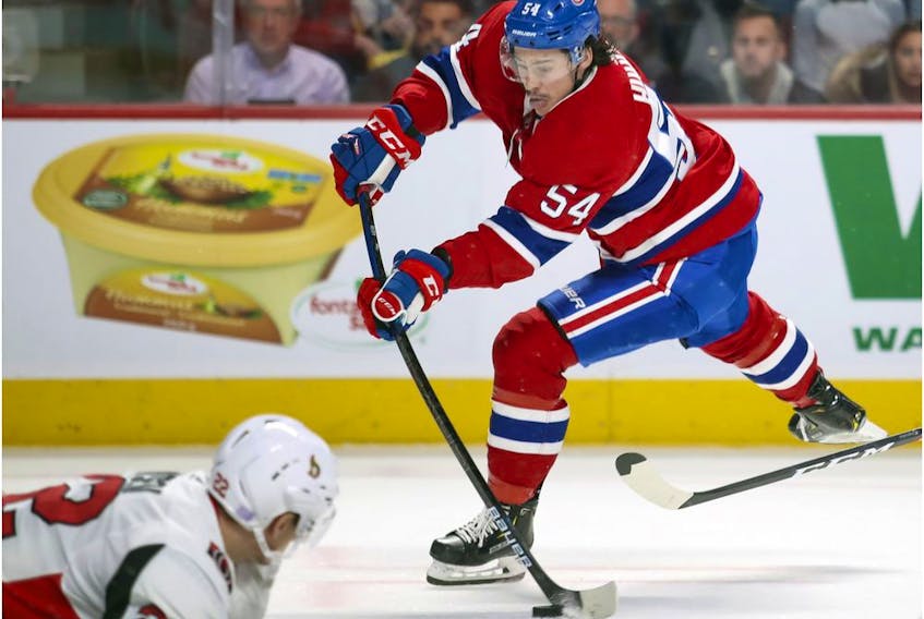  Montreal Canadiens’ Charles Hudon shoots the puck past a sliding Ottawa Senators Nikita Zaitzev during first period in Montreal on Nov. 20, 2019.
