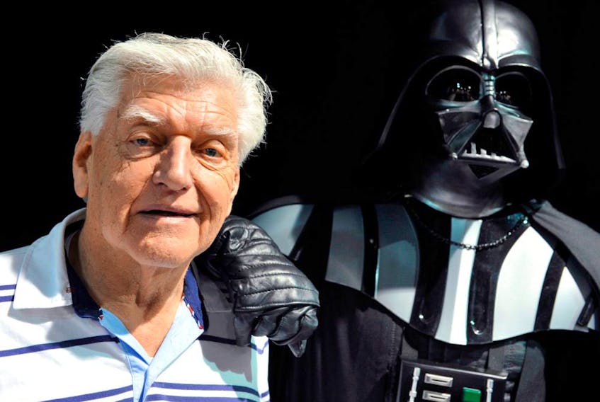 David Prowse, left, the British actor behind the menacing black mask of "Star Wars" villain Darth Vader who died on Nov. 29, attends a "Star Wars" convention in 2013.