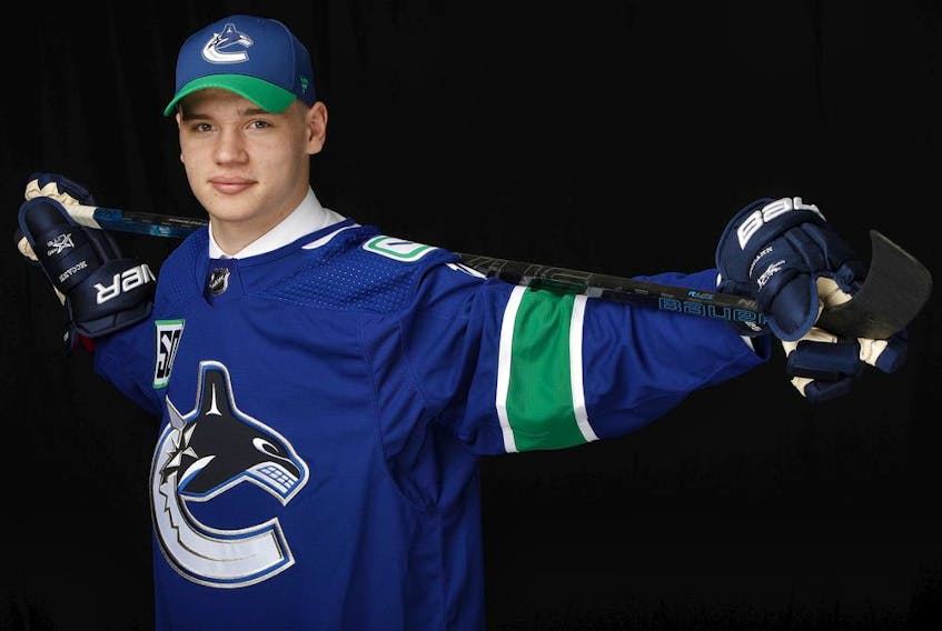 Vasili Podkolzin poses for a portrait after being selected 10th overall by the Vancouver Canucks during the first round of the 2019 NHL Entry Draft at Rogers Arena in Vancouver.