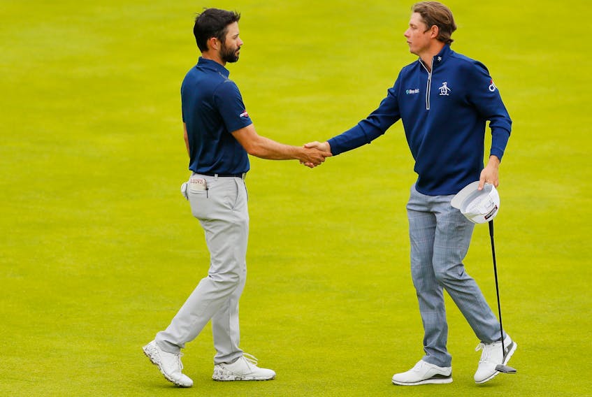 Cameron Smith of Australia, right, shakes hands with Adam Hadwin of Canada on the 18th green during the second round of the 148th Open Championship held on the Dunluce Links at Royal Portrush Golf Club on July 19, 2019 in Portrush, Northern Ireland. (Kevin C. Cox/Getty Images)
