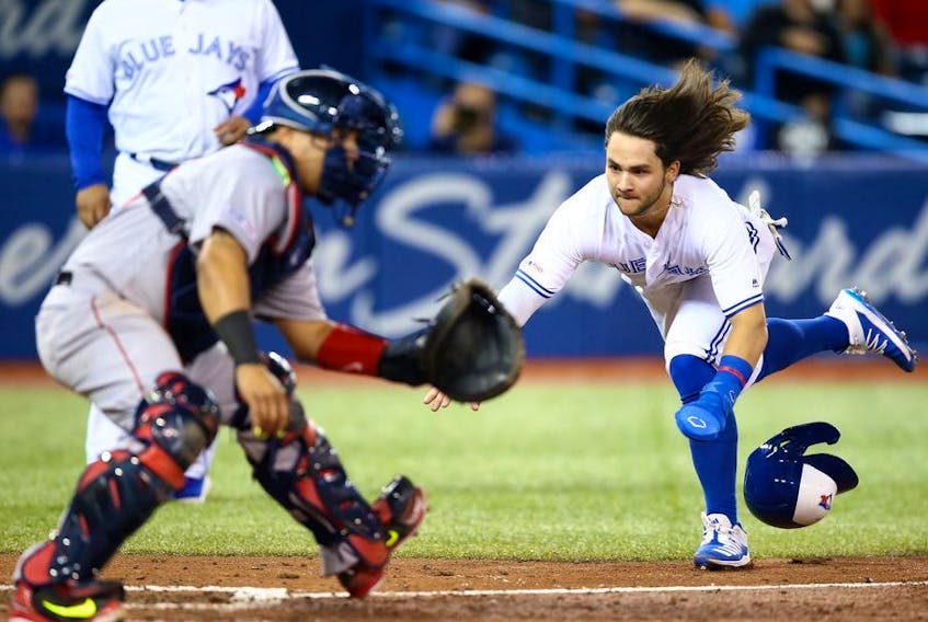Bo Bichette of the Toronto Blue Jays scores a run on a triple by Cavan Biggio #8 in the fifth inning during a MLB game against the Boston Red Sox at Rogers Centre on September 12, 2019 in Toronto, Canada.
